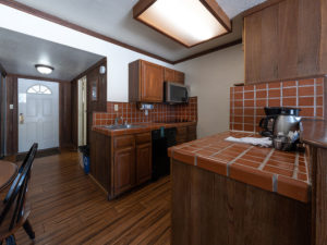One bedroom lakeside condo. View of full kitchen with red tile countertops