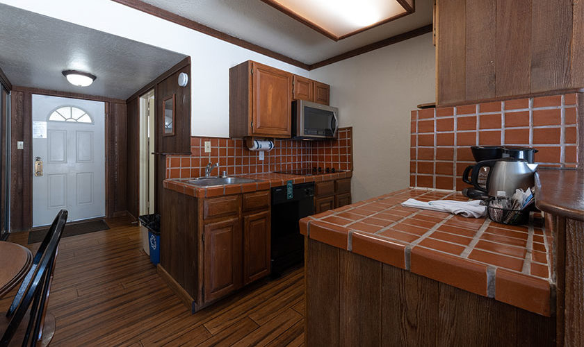 One bedroom lakeside condo. View of full kitchen with red tile countertops