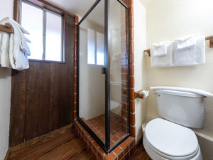 One bedroom lanai condo. Bathroom with glass shower and toilet