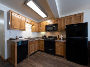 Two bedroom condo at Tahoe Sands Resort kitchen with black appliances (refrigerator, microwave, oven and dishwasher)