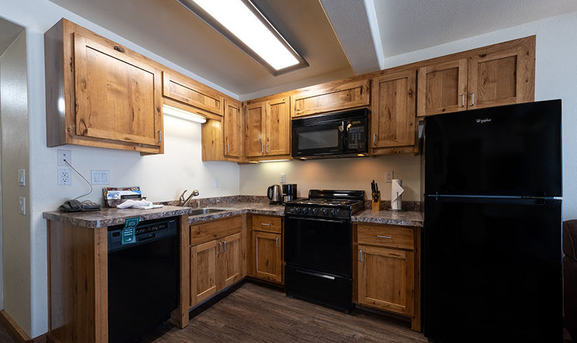 Two bedroom condo at Tahoe Sands Resort kitchen with black appliances (refrigerator, microwave, oven and dishwasher)