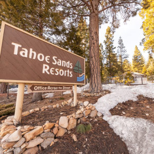 Tahoe Sands Resort property welcome sign with snow