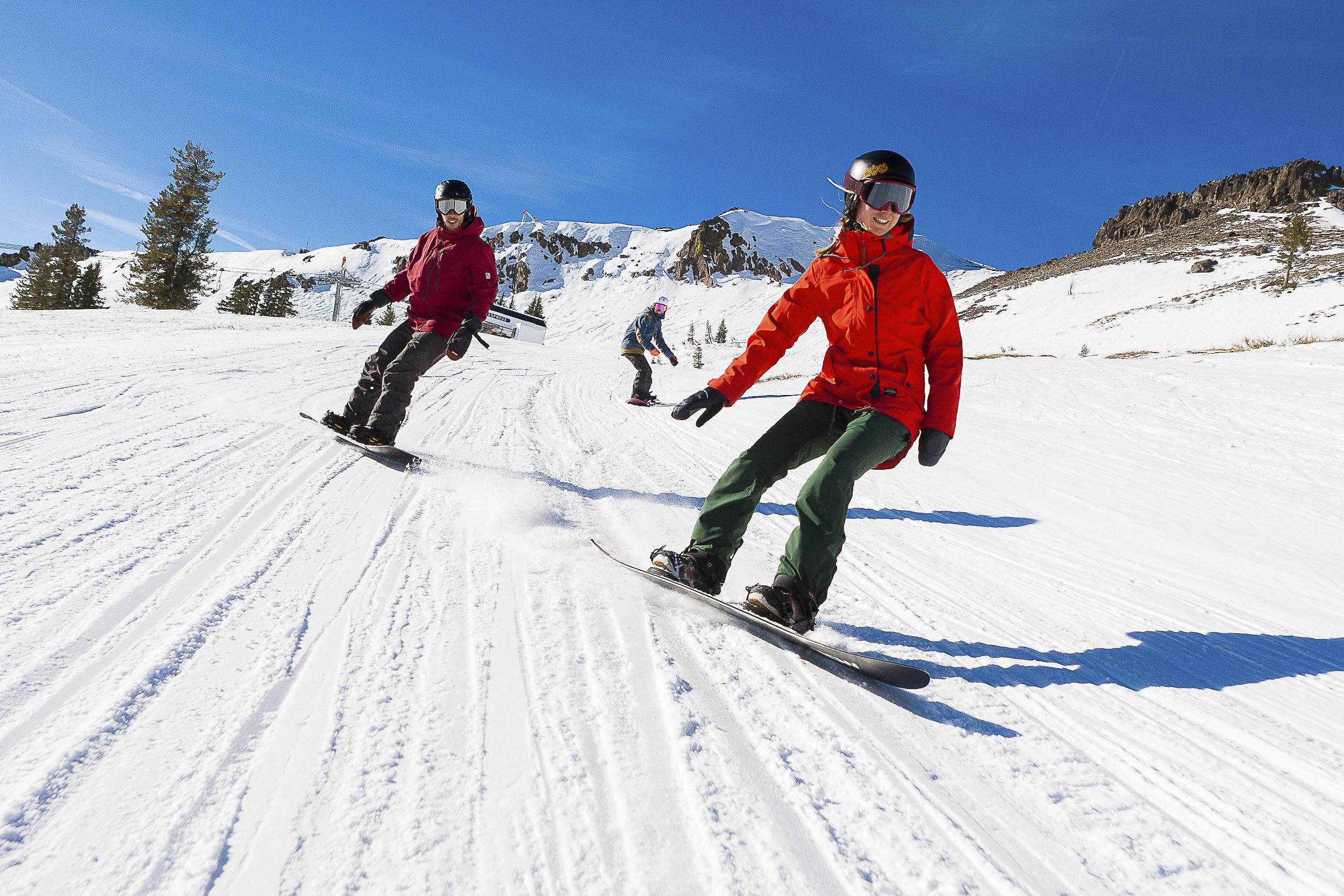 3 people snowboarding