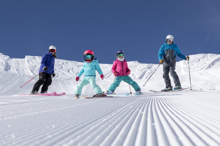 family skiing groomers at Alpine Meadows