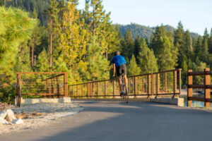 man biking on road around Lake Tahoe