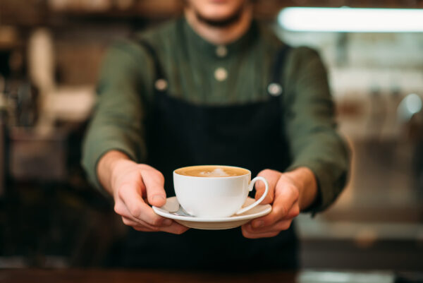 barista serving cup of coffee